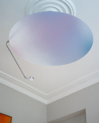 Sunday Light switched off, showing its sculptural iridescent disc on a period ceiling with ceiling rose